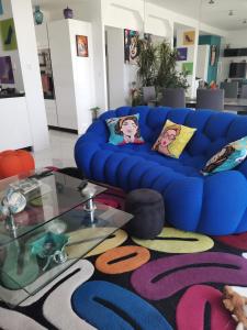 - un canapé bleu dans le salon avec une table en verre dans l'établissement Marina dream, à Toulon