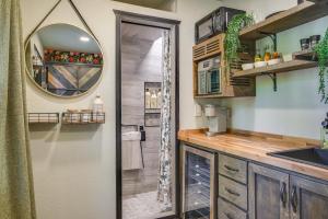 a bathroom with a shower and a sink and a mirror at Lakewood Vacation Rental - Walk to American Lake! in Tacoma