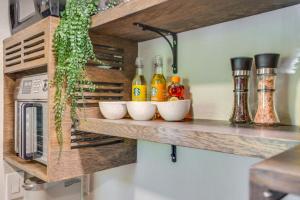 a kitchen with a shelf with bottles on it at Lakewood Vacation Rental - Walk to American Lake! in Tacoma +16 photos