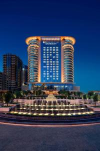 un gran edificio con una fuente frente a él en JW Marriott Absheron Baku Hotel, en Baku