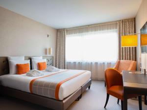 Postel nebo postele na pokoji v ubytování Mercure Clermont Ferrand centre Jaude