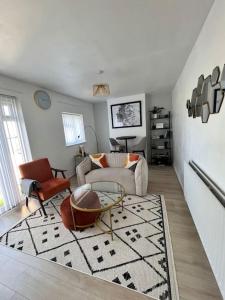 - un salon avec un canapé, des chaises et un tapis dans l'établissement Luxury 1bed Flat,Southend-on-sea, à Southend-on-Sea