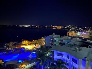 a night view of a building with a swimming pool at Exclusive Apartment with Ocean Views in Caloundra