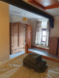 a bedroom with a bed and a dresser and a window at Salutation Inn in Carmarthen