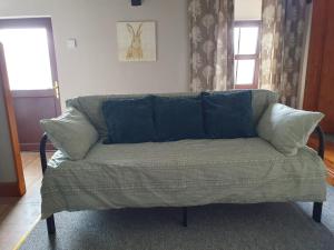 a couch with blue pillows in a living room at Salutation Inn in Carmarthen