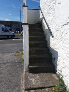 a set of stairs next to a white wall at Salutation Inn in Carmarthen