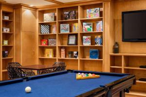 a billiard room with a pool table and shelves at Viana Hotel and Spa, Trademark Collection by Wyndham in Westbury