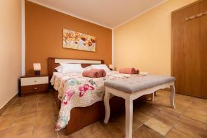 a bedroom with a bed and a table in it at Apartman "ELA" in Njivice