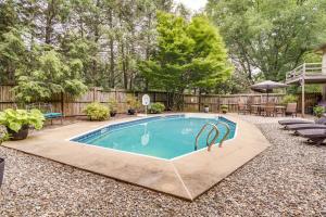 a swimming pool in a yard with a wooden fence at Inviting Lancaster Vacation Home 3 Mi to Downtown in Lancaster