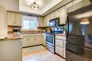 a kitchen with white cabinets and a black refrigerator at Inviting Lancaster Vacation Home 3 Mi to Downtown in Lancaster