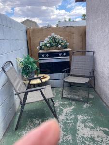 a patio with two chairs and a table and a dresser at “Beautifull Cozy Studio…With Private Entrance” in Las Vegas