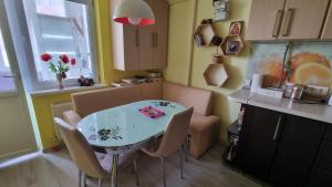 a kitchen with a table and chairs in a kitchen at Cozy Retreat in Quiet Location in Chişinău