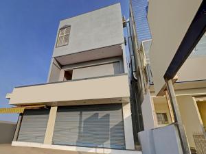 a facade of a building with roller blinds on it at OYO Home Mishra Suites in Bangalore