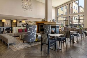 a lobby with tables and chairs and a fireplace at Residence Inn by Marriott Los Angeles Redondo Beach in Redondo Beach