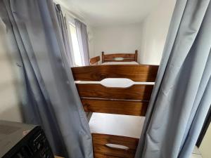 a small bedroom with a bed and a window at Pavillon Climatisé dans résidence avec Piscine - Narbonne Plage 4BS14 in Narbonne-Plage