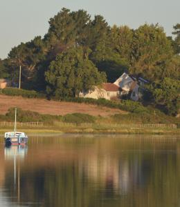 a small boat sitting on the water in a lake at River View in Aldeburgh