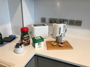 a kitchen counter with a coffee maker and a toaster at Quality City Birmingham in Birmingham