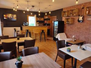 a restaurant with tables and chairs and a bar at Õ 2040 in Saint-Véran