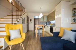 a living room with a blue couch and a kitchen at Modern, Stylish Maisonette in Itea