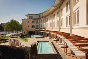 a view of a building with a swimming pool at Ad Astra by Elite - Hotel, Spa & Resort in Södertälje