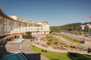 a building with a swimming pool and a courtyard at Ad Astra by Elite - Hotel, Spa & Resort in Södertälje