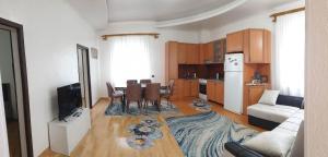 a kitchen and living room with a table and a couch at Nino's apartment-Isolated floor for rent in Tbilisi City