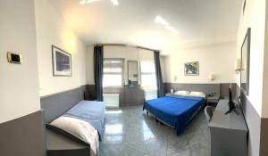 a bedroom with two beds and a blue blanket at Keb Hotel Vitruvio in Milan
