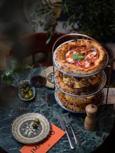 a table topped with a pizza on top at Ad Astra by Elite - Hotel, Spa & Resort in Södertälje