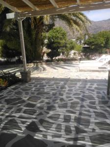 a patio with a geometric pattern on the floor at Eden Ios Rooms in Mylopotas