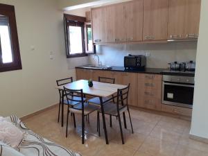 a kitchen with a table and chairs in a room at Maria's home - Katelios in Katelios