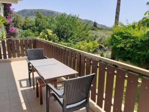 a table and chairs on a balcony with a view at Maria's home - Katelios in Katelios