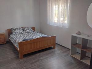 a small bedroom with a bed and a window at Pag Sea Mare in Pag