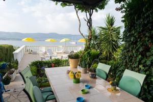 een tafel met stoelen en bloemen op een patio bij Villa Fjaba - by the sea - with the big terraces & great sea view in Trogir