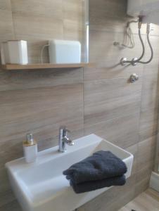 a bathroom with a sink and a mirror at Pag Sea Mare in Pag