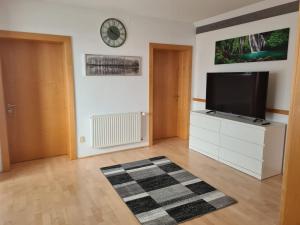 a living room with a flat screen tv on a white cabinet at Ferienwohnung Familie Wieser in Liebenfels