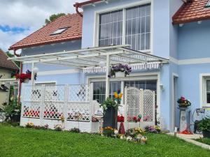 a white pergola on the front of a house at Ferienwohnung Familie Wieser in Liebenfels