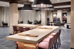 a conference room with a large table and chairs at Courtyard by Marriott Atlanta Duluth Downtown in Duluth
