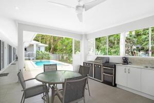 a kitchen and dining room with a table and a pool at SeaBreeze Studios ( Room 1 ) - Palm Cove in Palm Cove