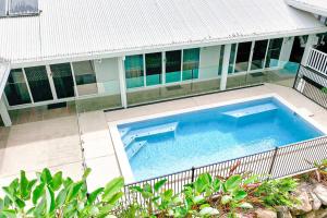 a large swimming pool in front of a building at SeaBreeze Studios ( Room 1 ) - Palm Cove in Palm Cove