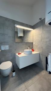 a bathroom with a white sink and a toilet at Apartment DreamVille in Crikvenica