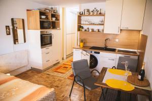 a small kitchen with a table and a dining room at Sončni apartma in Bovec