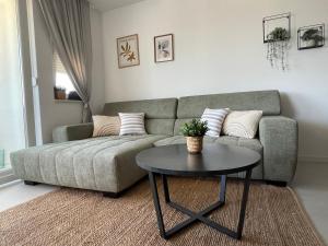 a living room with a couch and a table at Luxury apartment Golden Mint in Novalja