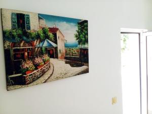a painting of a street in a city on a wall at Apartmani SAMB Igalo in Herceg-Novi