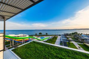 a view of a playground next to the water at Voya Beach Resort - Ultra All Inclusive in Sveti Vlas