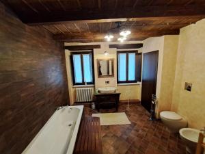 a large bathroom with a tub and a sink at I Templari - Affittacamere in Castignano +104 photos