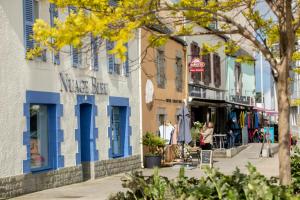 a street in a town with people walking down the street at Le Kador, appartement avec vue sur mer in Crozon