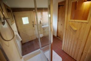 a bathroom with a shower and a sink at White Horse Cottage with Sauna in Ollerton