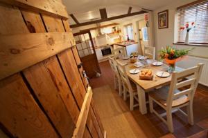 a kitchen and dining room with a table and chairs at White Horse Cottage with Sauna in Ollerton