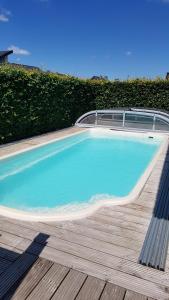 a swimming pool with a bench on a wooden deck at Ferienhaus Mone in Monschau