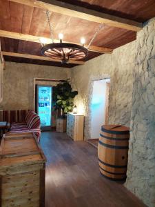 a wine tasting room with a barrel and a chandelier at Penzion Felden in Jablonné v Podještědí